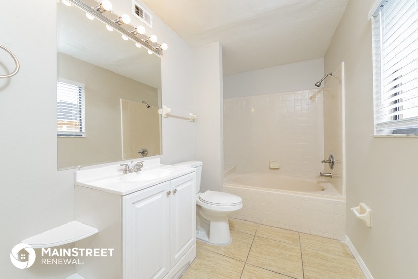 a bathroom with a sink toilet and a bath tub