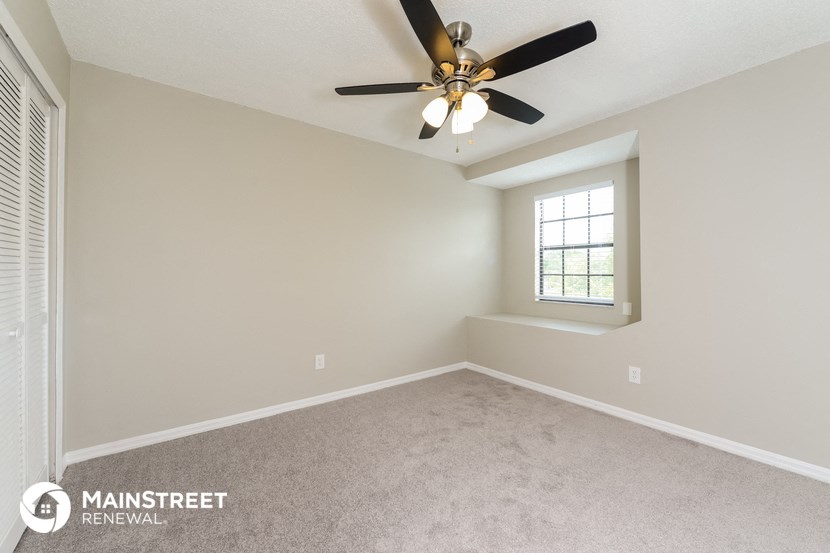 the master bedroom is spacious and has a ceiling fan