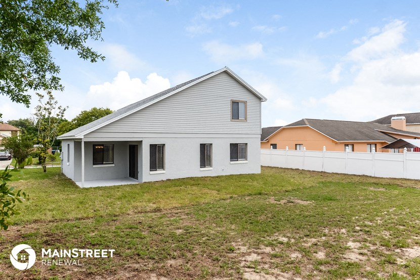a white house with a yard and a white fence