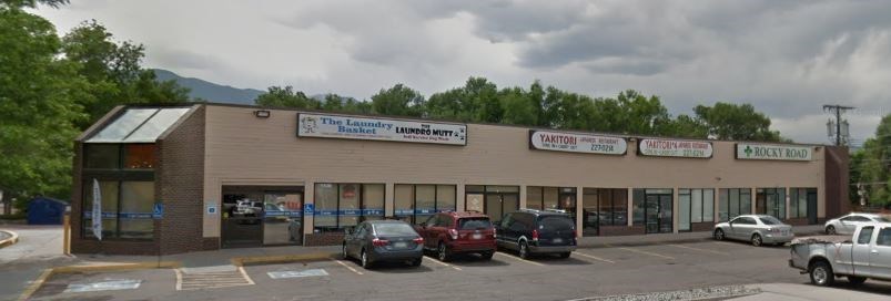 A parking lot in front of a building with a sign that says "The Local".