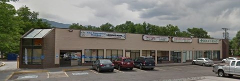 A parking lot in front of a building with a sign that says "The Local".