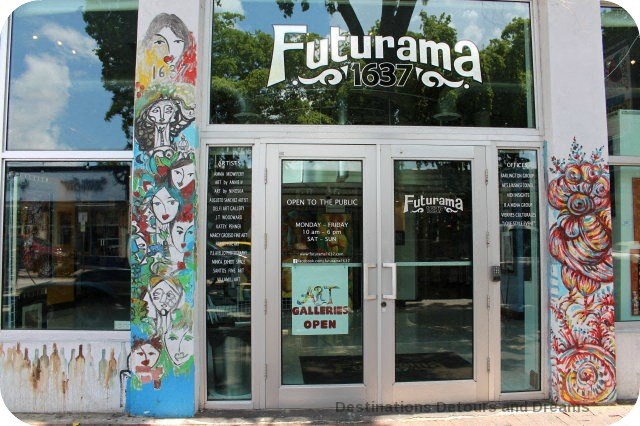 the front of a restaurant with graffiti on the doors