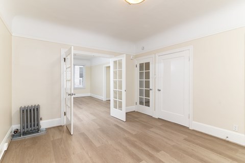A room with a white door and a window.