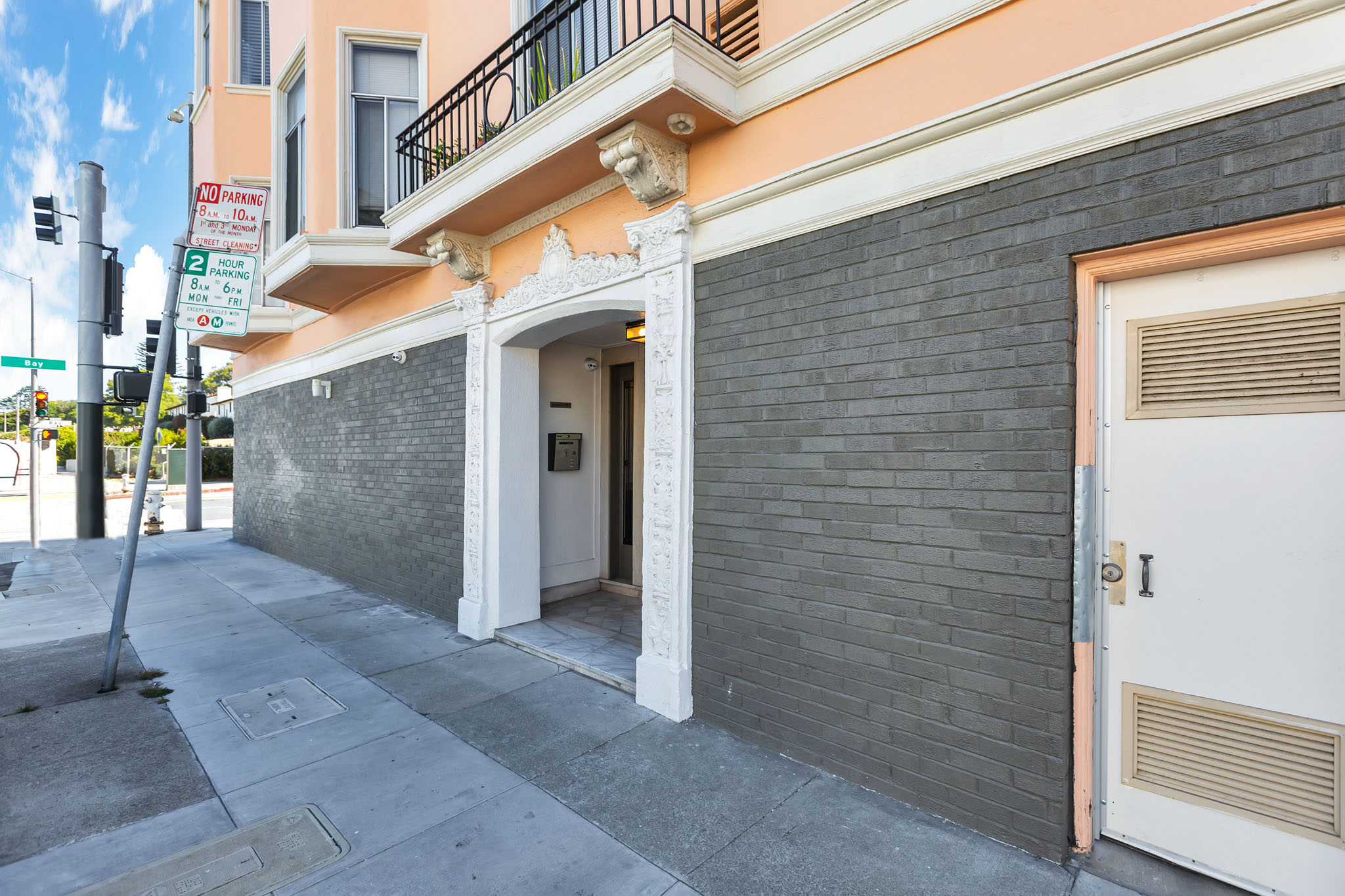 A building with a white door and a black wall.