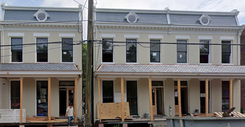 a building is being remodeled in front of another building
