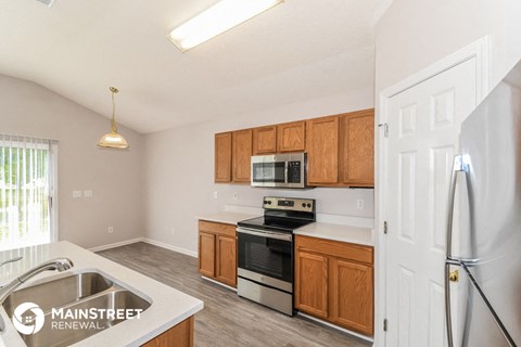 a kitchen with wooden cabinets and stainless steel appliances