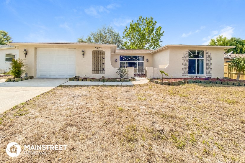 a house with a yard and a driveway and a garage door