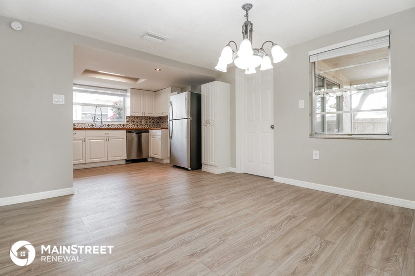 the kitchen is open to the dining room and living room