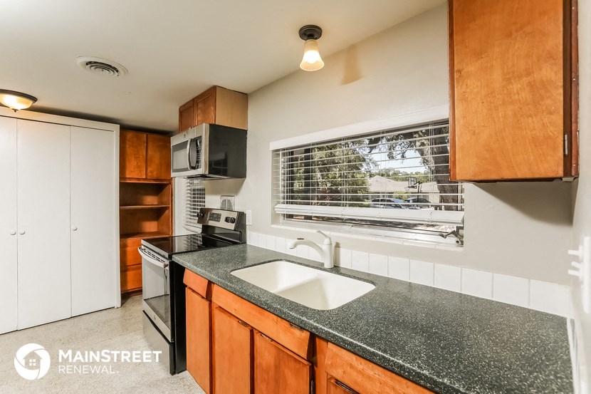 a kitchen with granite counter top and a sink