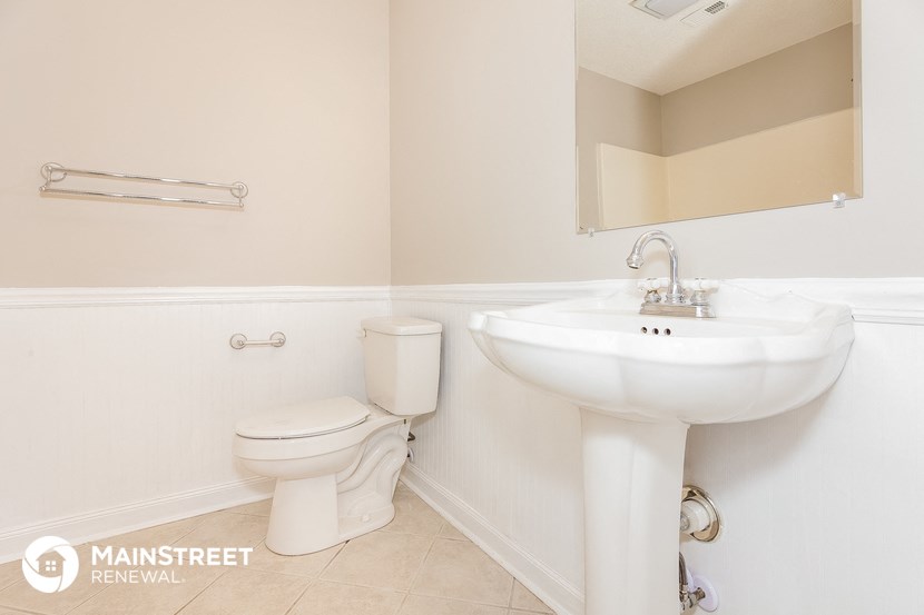 a bathroom with a sink and a toilet and a mirror