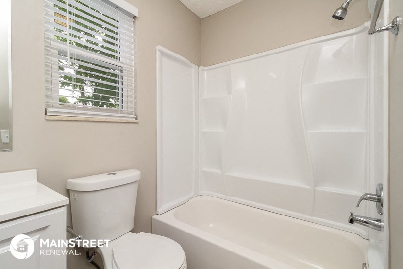 a bathroom with a tub and a toilet and a sink