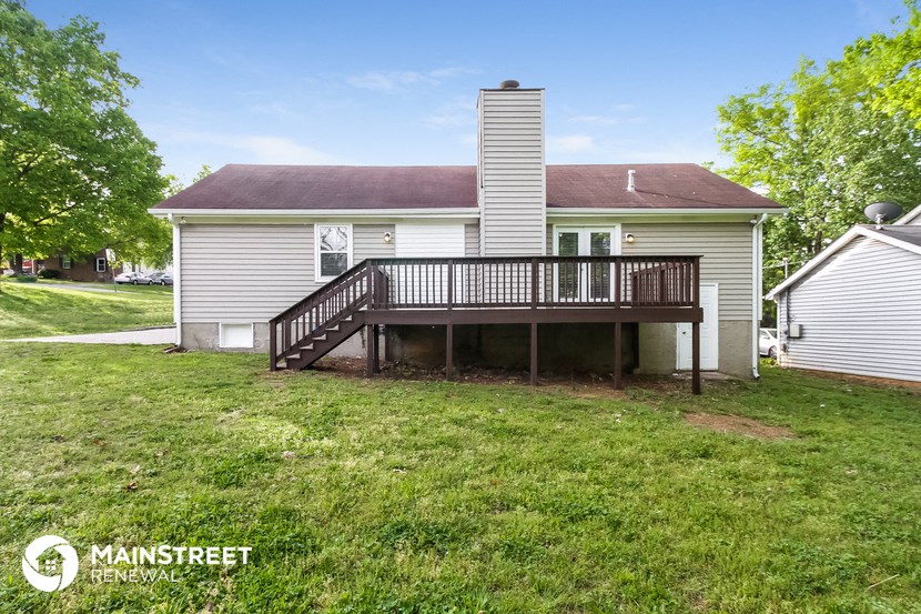 the back of a house with a deck and a porch