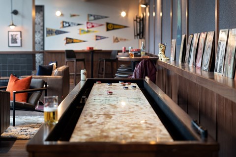A pool table in a room with a couch and a chair.
