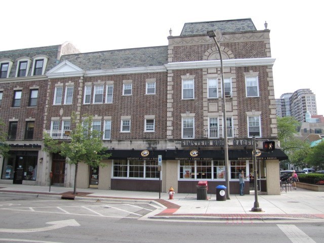 a large brick building on the corner of a street