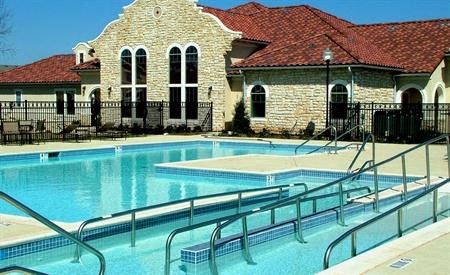 a large swimming pool in front of a house