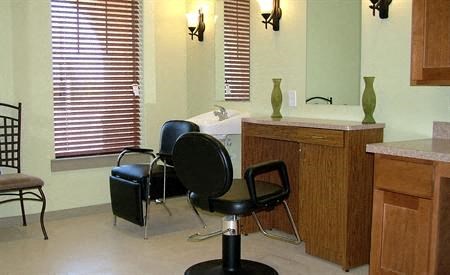 a bathroom with a chair and a sink and a window