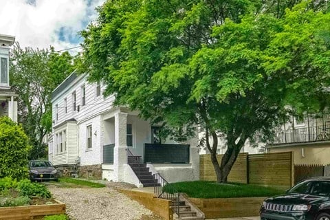 a white house with a tree in front of it