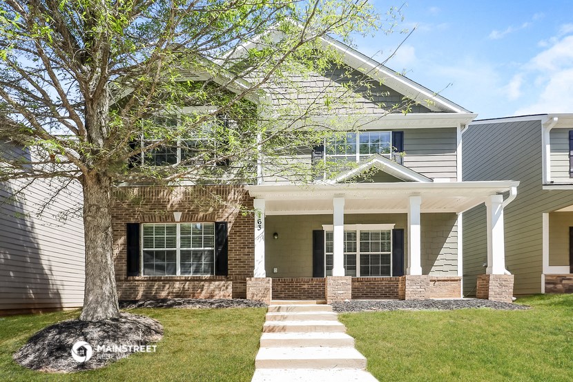 a white house with a tree in front of it