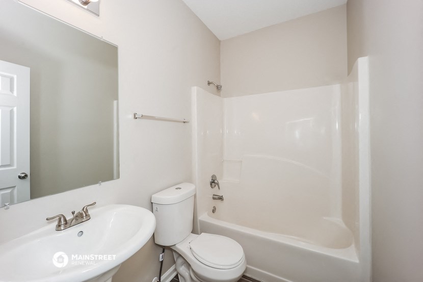 a bathroom with a sink toilet and a bath tub