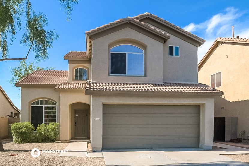 a house with a garage door in front of it