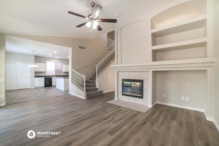 a living room with a fireplace and a staircase