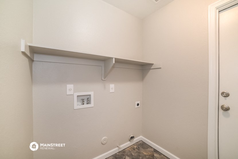 the upstairs bedroom has a wall shelf and a door to the bathroom