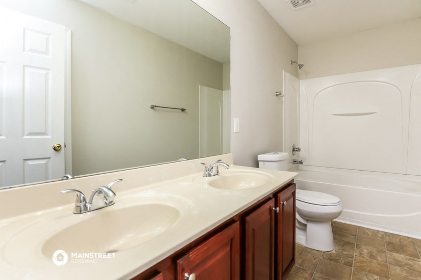 a bathroom with a sink and a toilet and a mirror