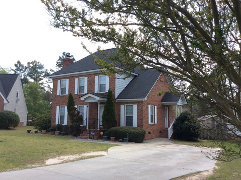 a large brick house with a driveway in front of it