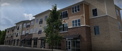 a new apartment building on the corner of a street