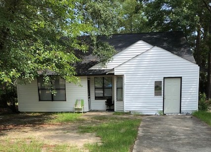 a white house with a green chair in front of it