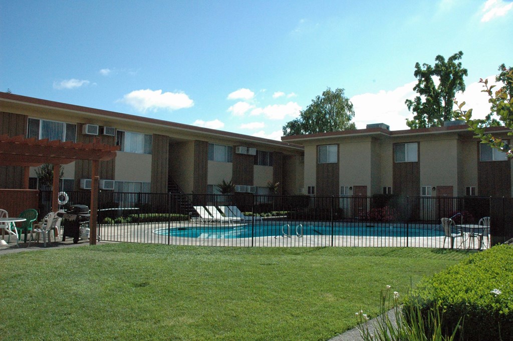 a yard with a swimming pool in an apartment building