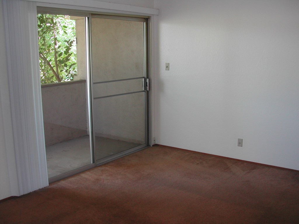 an empty room with a sliding glass door