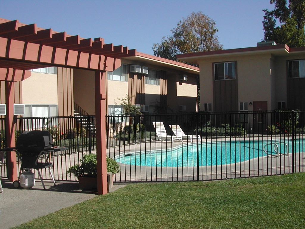 a swimming pool in front of an apartment building