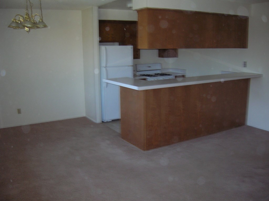 an empty kitchen with an island in the middle of it