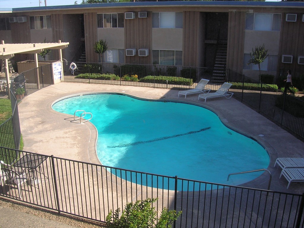 a view of a swimming pool in front of an apartment building