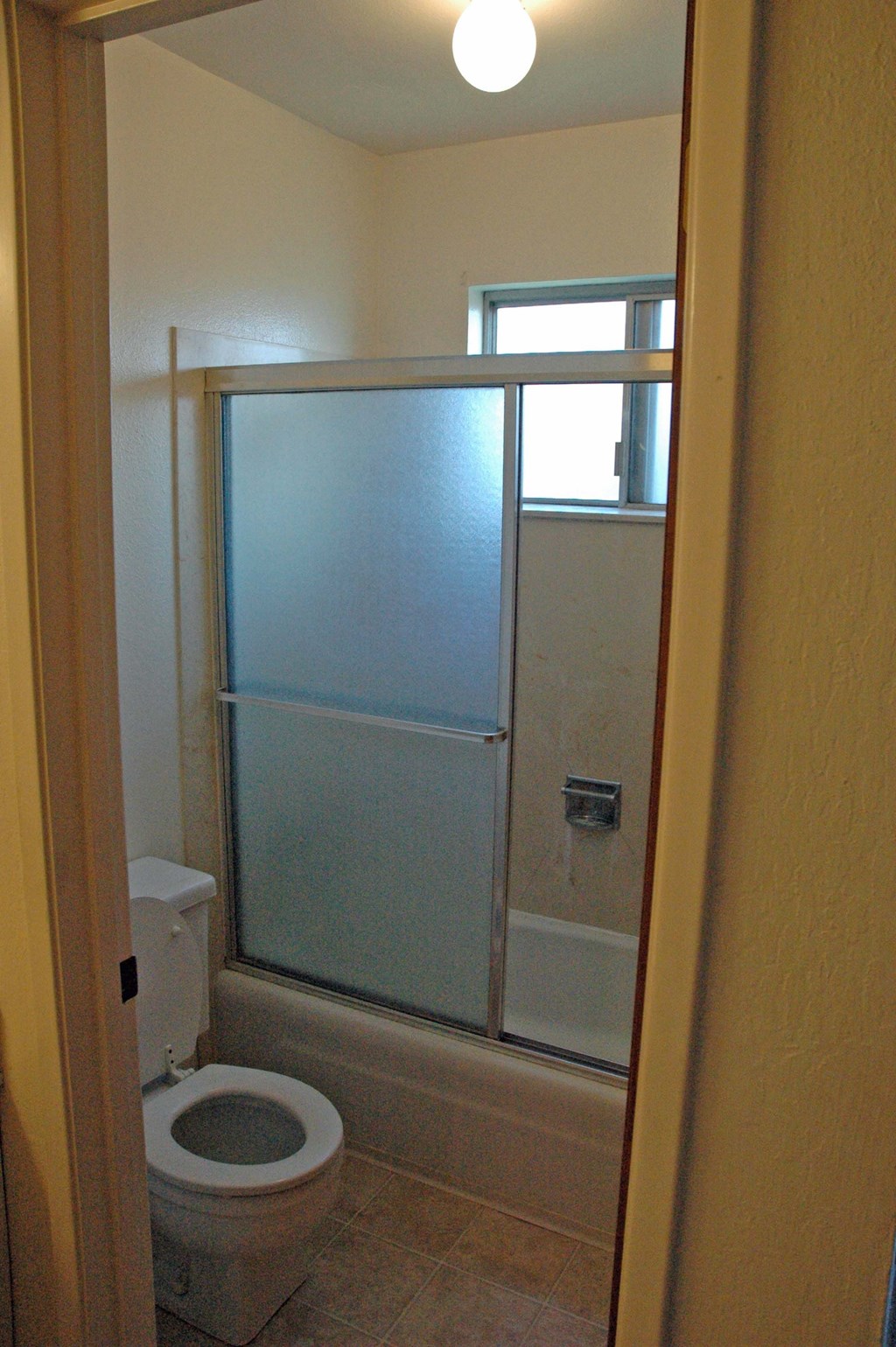 a small bathroom with a shower and a toilet