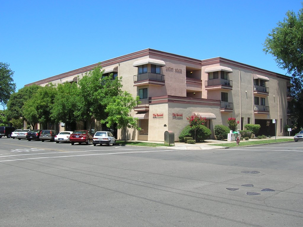 an apartment building on the corner of a city street
