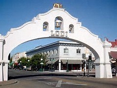 a white building with an arch over a street