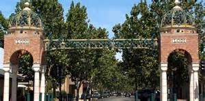 two brick archways with trees in front of a building