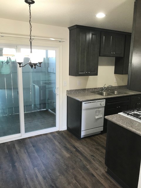 an empty kitchen with a sliding glass door to the bathroom