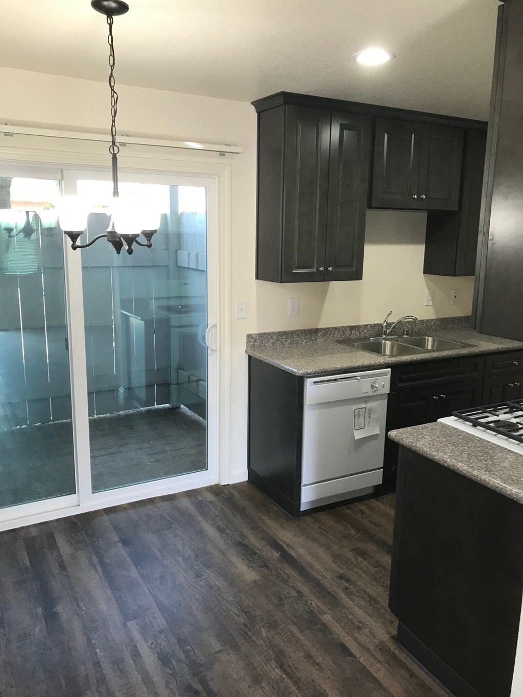 an empty kitchen with a sliding glass door to the bathroom