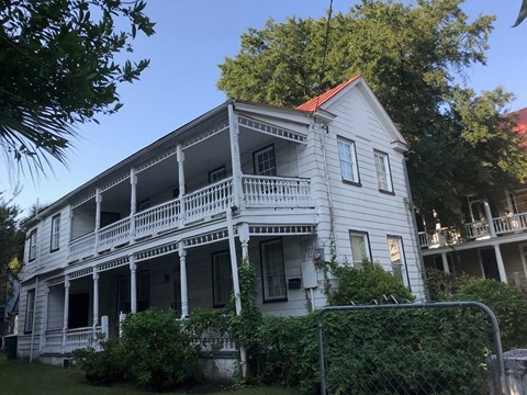 an old with a balcony and a fence