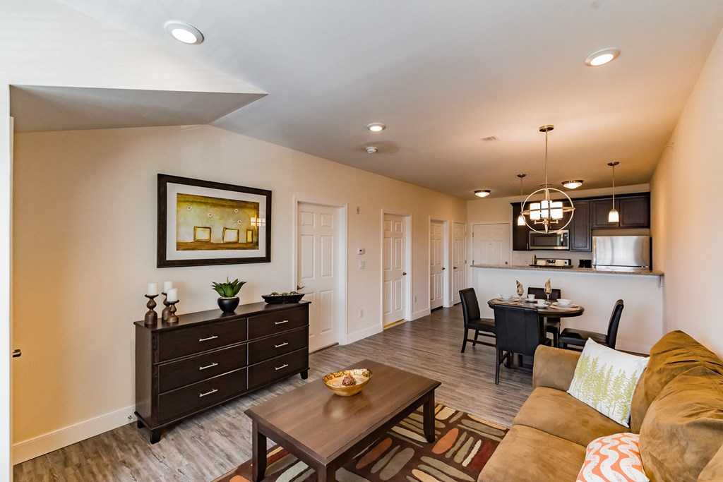 a living room and kitchen with a couch and a table