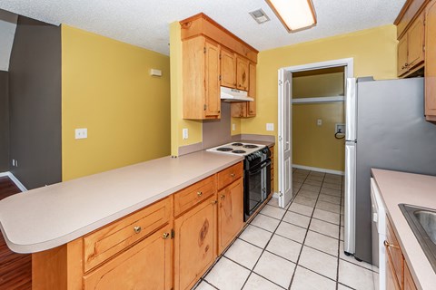 A kitchen with wooden cabinets and a white countertop.