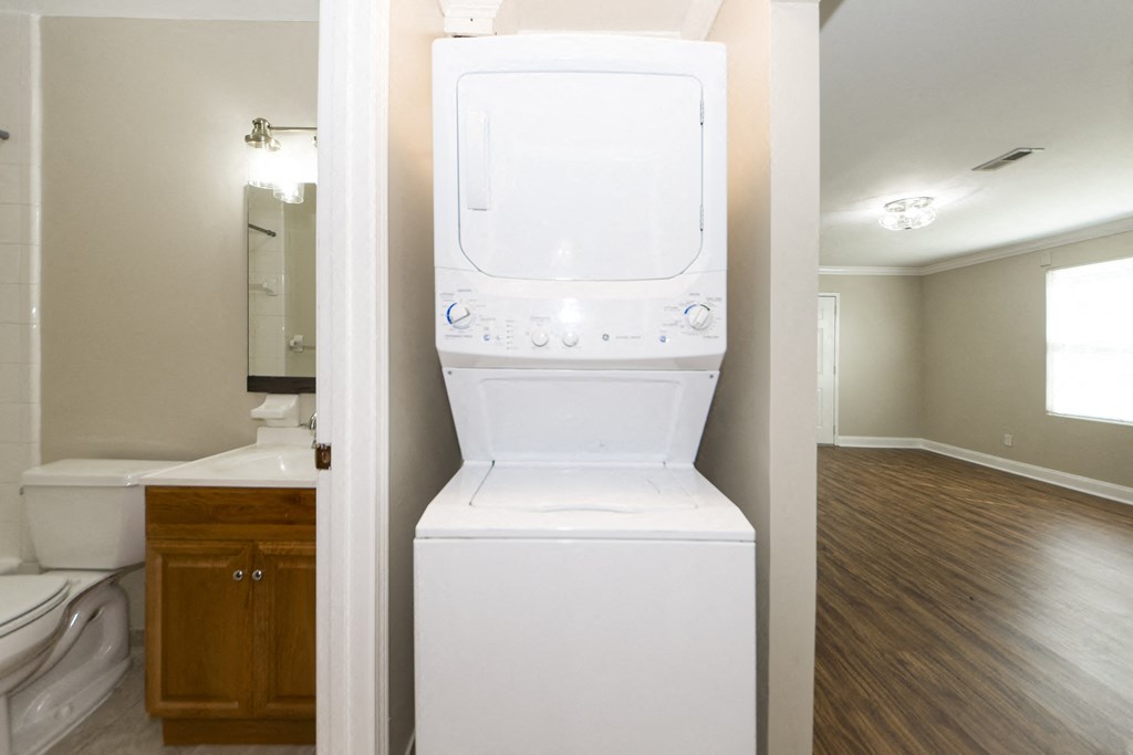 an empty laundry room with a washer and dryer