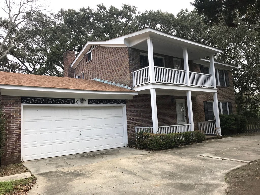 a brick house with a white garage door