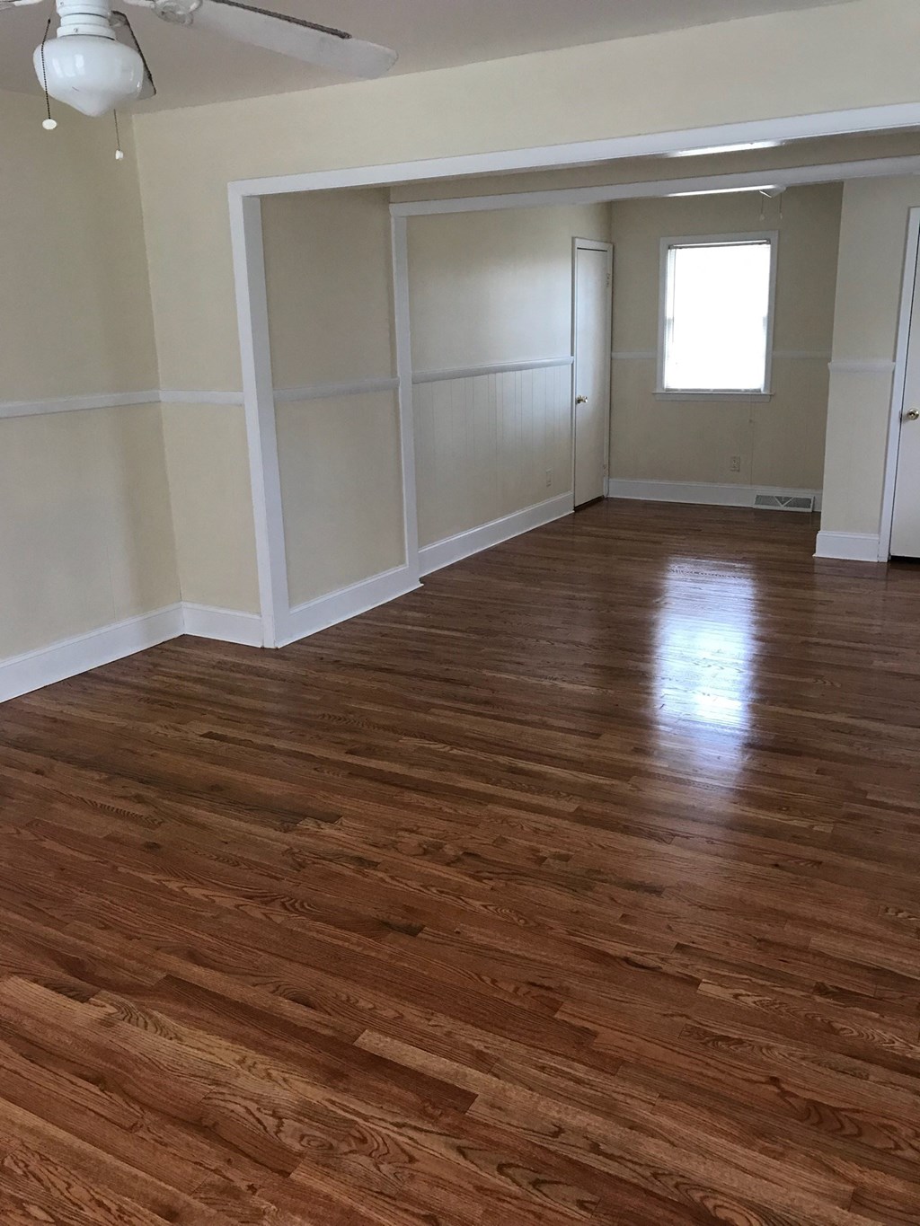A room with wooden floors and white walls.