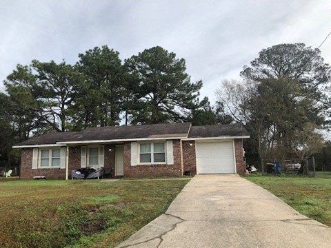 A house with a driveway in front of it.