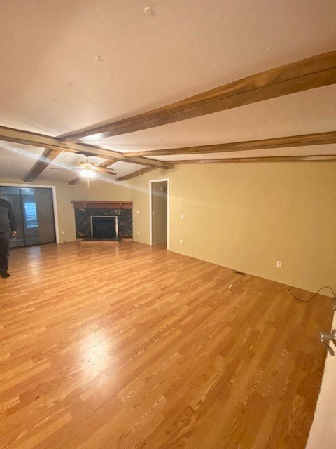 A room with wooden flooring and a person standing in the doorway.