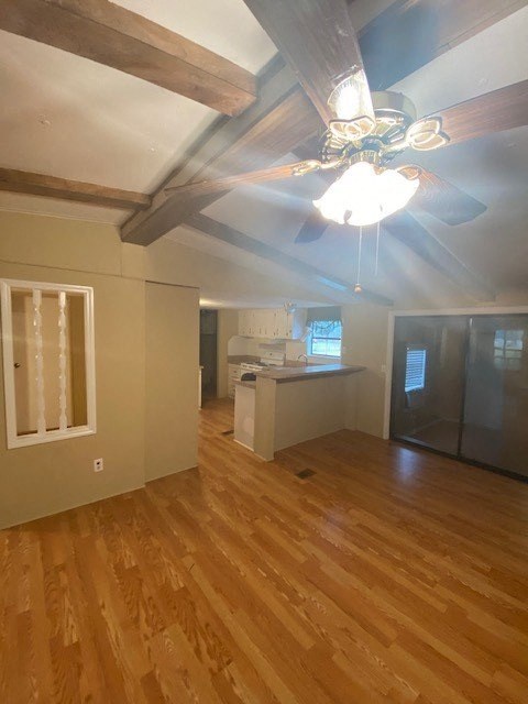 A room with wooden floors and a ceiling fan.